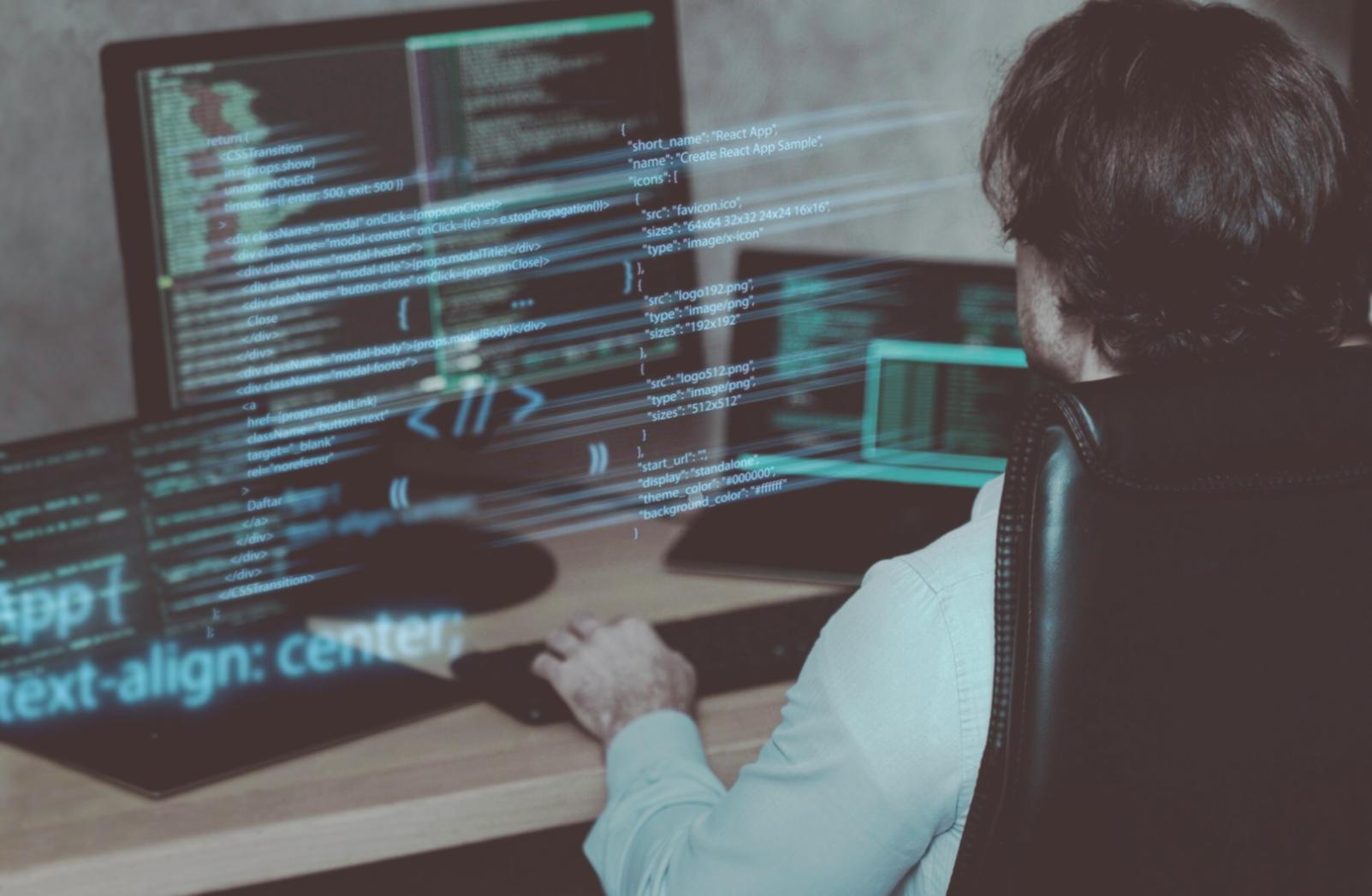 Developer working on automated testing framework code with multiple monitors showing test results and system architecture